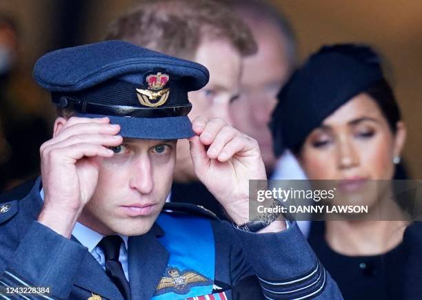 Britain's Prince William, Prince of Wales , Britain's Prince Harry, Duke of Sussex and Meghan, Duchess of Sussex leave after a service for the...