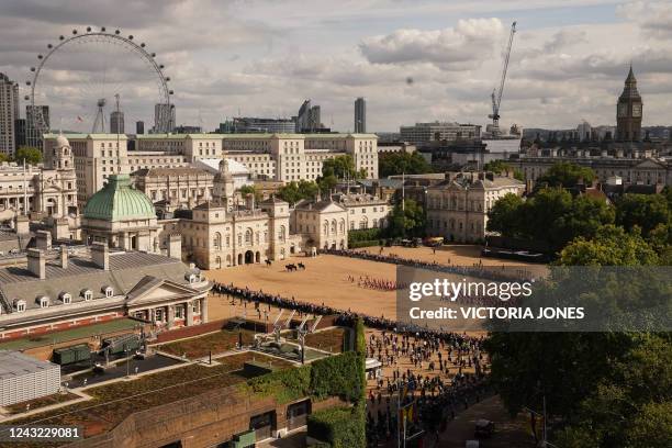 General view of the coffin of Queen Elizabeth II, adorned with a Royal Standard and the Imperial State Crown and pulled by a Gun Carriage of The...