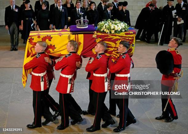 Pallbearers from The Queen's Company, 1st Battalion Grenadier Guards carry the coffin of Queen Elizabeth II into Westminster Hall at the Palace of...