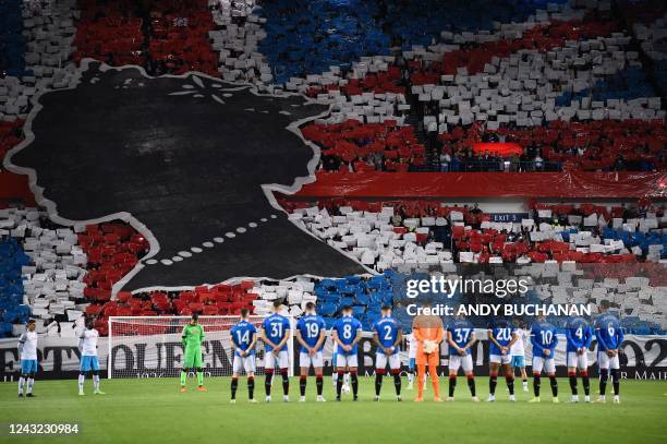 Rangers' and Napoli's player observe a minute's silence to mark the death of Britain's Queen Elizabeth II ahead of the UEFA Champions League Group A...