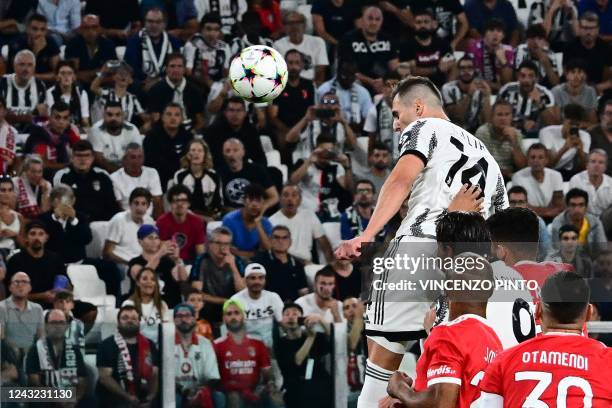 Juventus' Polish forward Arkadiusz Milik jumps to score a header and open the scoring during the UEFA Champions League Group H football match between...