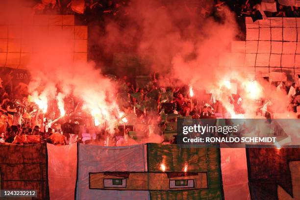 Maccabi Haifa's fans light flares in the stands during the UEFA Champions League group H football match between Israel's Maccabi Haifa and France's...