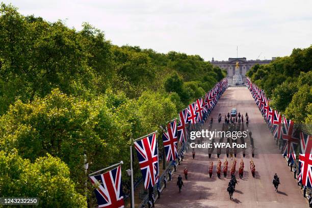 The coffin of Queen Elizabeth II is carried on a horse-drawn gun carriage of the King's Troop Royal Horse Artillery along the Mall during the...