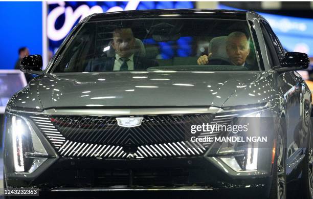 President Joe Biden drives a Cadillac LYRIQ as he tours the Detroit Auto Show at Huntington Place Convention Center in Detroit, Michigan on September...