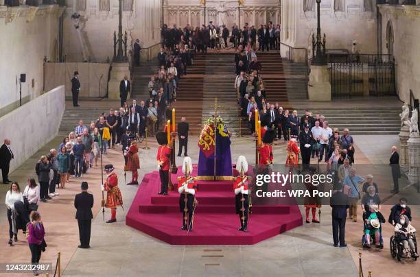 The first members of the public pay their respects as the vigil begins around the coffin of Queen Elizabeth II as it Lies in State inside Westminster...