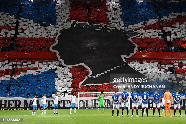 Rangers' and Napoli's player observe a minute's silence to mark the death of Britain's Queen Elizabeth II ahead of the UEFA Champions League Group A...