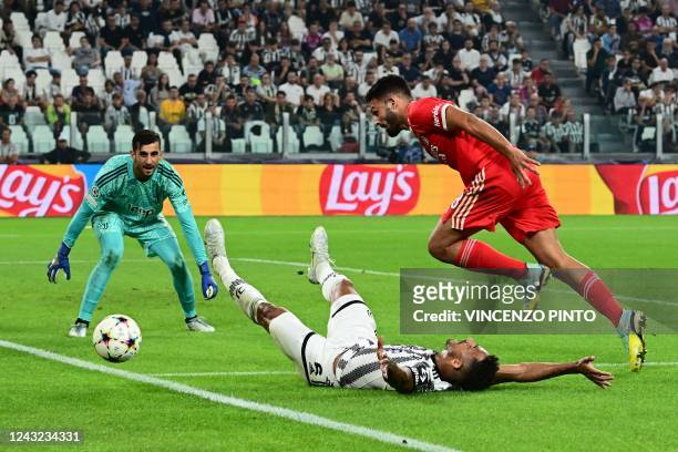 Benfica's Portuguese forward Goncalo Ramos challenges Juventus' Brazilian defender Danilo and Juventus' Italian goalkeeper Mattia Perin during the...