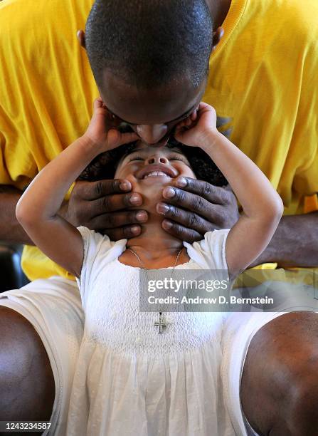 Kobe Bryant of the Los Angeles Lakers kisses his daughter Gianna Bryant during a photo session on March 29, 2008 at his home in Newport Beach,...