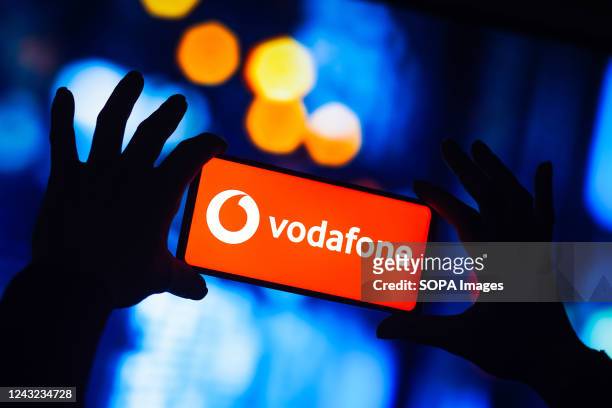 In this photo illustration, the Vodafone logo is seen displayed on a smartphone.