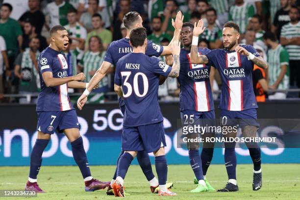 Paris Saint-Germain's Brazilian forward Neymar celebrates with his teammates after scoring a third goal during the UEFA Champions League group H...