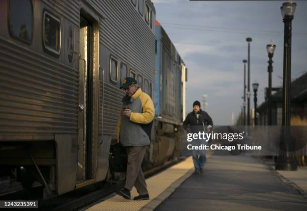 Commuters board a Metra train on the Union Pacific Northwest line in Barrington, Illinois, on March 16, 2020.