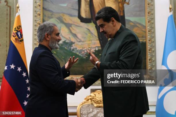 Venezuela's President Nicolas Maduro shakes hands with the Secretary General of the Organization of the Petroleum Exporting Countries , Kuwaiti...