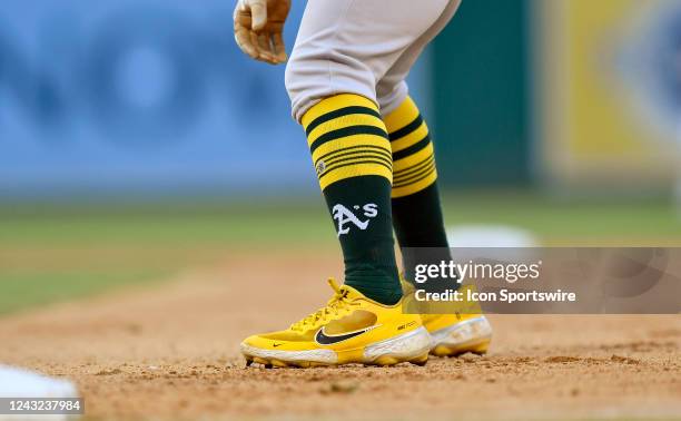 Close up view of Tony Kemps Oakland As logo baseball socks and yellow Nike React baseball cleats as he take a lead off from first base during the...