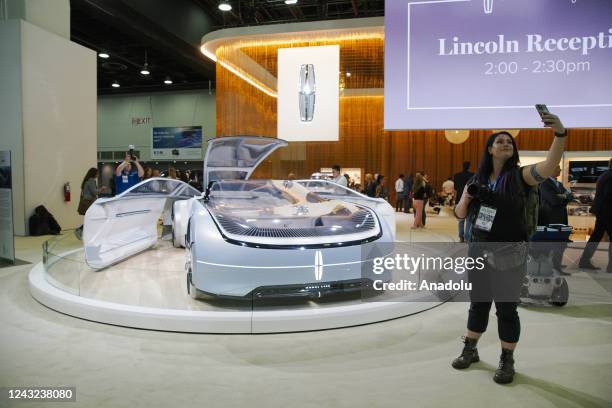 Woman takes a selfie with the Lincoln Model L100 at the Detroit Auto show, in Detroit, MI, United States on September 14, 2022.