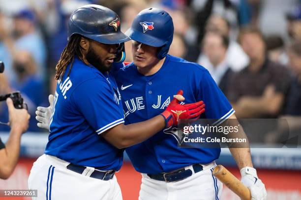 Vladimir Guerrero Jr. #27 of the Toronto Blue Jays celebrates his solo home run, his 100th career home run, with Matt Chapman in the first inning of...