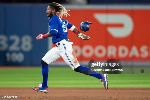 Raimel Tapia of the Toronto Blue Jays steals third off a hit by teammate Santiago Espinal in the sixth inning of their MLB game against the Tampa Bay...