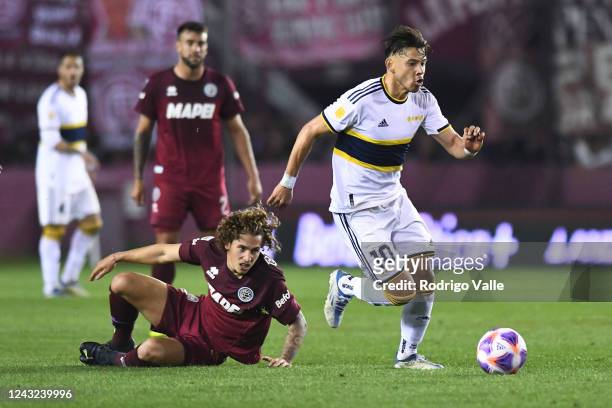 Oscar Romero of Boca Juniors drives the ball against Luciano Boggio of Lanus during a match between Lanus and Boca Juniors as part of Liga...