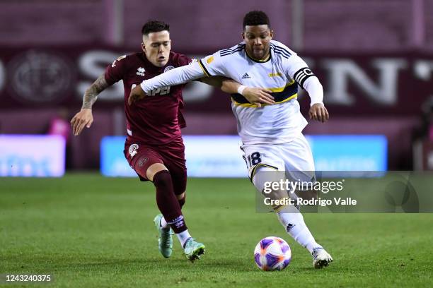 Frank Fabra of Boca Juniors fights for the ball with Franco Troyansky of Lanus during a match between Lanus and Boca Juniors as part of Liga...