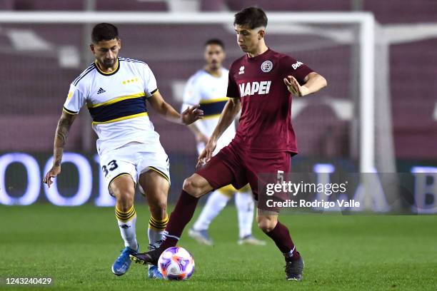 Tomas Belmonte of Lanus drives the ball against Alan Varela of Boca Juniors during a match between Lanus and Boca Juniors as part of Liga Profesional...