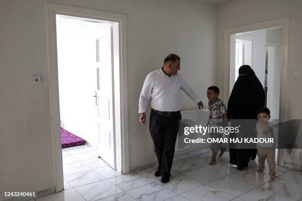 Mutassem Abd al-Sater, 42-year-old former inmate at Sednaya prison, accompanied by his wife Bara'ah and children Othman and Abdel Sattar , gives an...