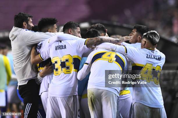 Dario Benedetto of Boca Juniors celebrates wih teammates after scoring the first goal of his team during a match between Lanus and Boca Juniors as...