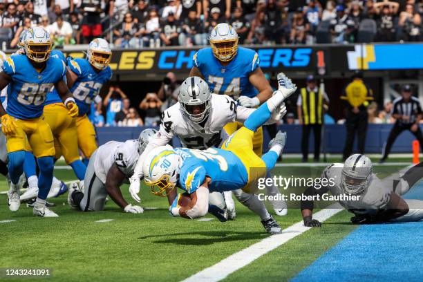 Inglewood, CA, Sunday, September 11, 2022 - Los Angeles Chargers running back Austin Ekeler is tripped at the goal line by Las Vegas Raiders...