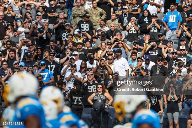 Inglewood, CA, Sunday, September 11, 2022 - Chargers players line up near the goal line as a multitude of Raiders fans show their support of Las...