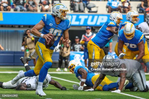 Inglewood, CA, Sunday, September 11, 2022 - Los Angeles Chargers quarterback Justin Herbert rolls out to pass against the Las Vegas Raiders at SoFi...