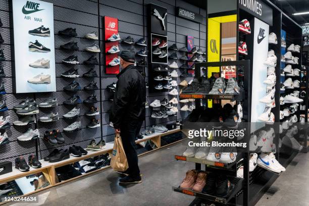 Customer browses Nike Inc. Sports shoes while shopping at a store in Strasbourg, France, on Wednesday, Sept. 14, 2022. French Finance Minister Bruno...