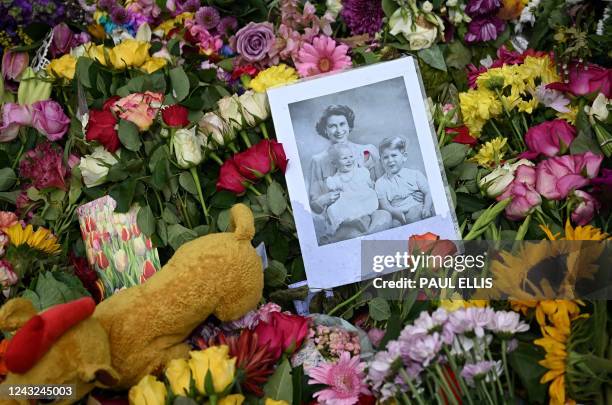 Flowers and tributes are pictured left in Green Park in London on September 15 following the death of Queen Elizabeth II on September 8. - Queen...