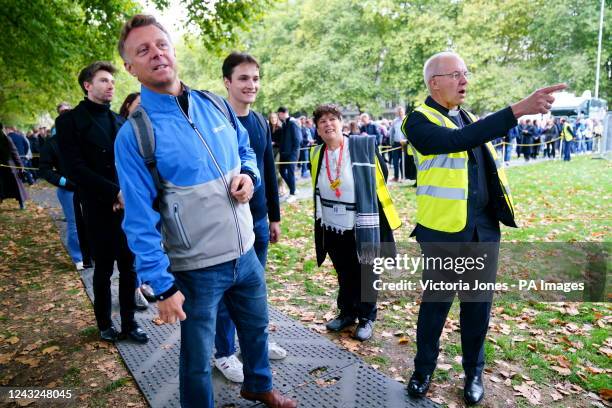 The Archbishop of Canterbury Justin Welby talks to people near the final section of the queue to see the coffin of Queen Elizabeth II outside the...