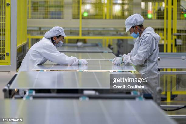 Worker produces solar photovoltaic module products at a production line in Hefei, Anhui province, China, Sept 15, 2022.