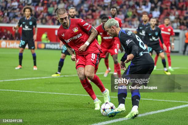 Robert Andrich of Bayer 04 Leverkusen and Antoine Griezmann of Atletico Madrid battle for the ball during the UEFA Champions League group B match...