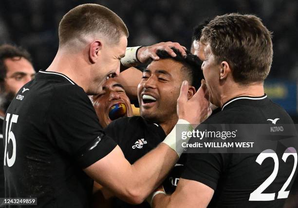 New Zealand's Richie Mounga celebrates with teammates after scoring a try during the Rugby Championship match between Australia and New Zealand at...