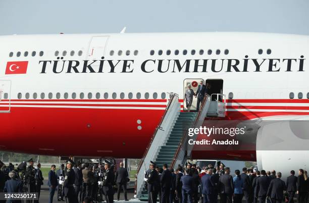 Turkish President Recep Tayyip Erdogan and his wife Emine Erdogan get off the plane as they arrive at the airport in Samarkand, Uzbekistan on...