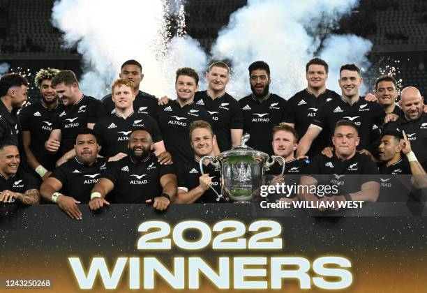 New Zealand's players celebrate with the trophy after winning the Rugby Championship after their match against Australia at Marvel Stadium in...