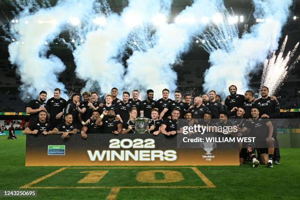 New Zealand's players celebrate with the trophy after winning the Rugby Championship after their match against Australia at Marvel Stadium in...