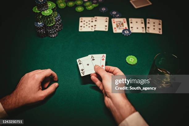 man holding two aces in poker game - casino tables hands stock pictures, royalty-free photos & images