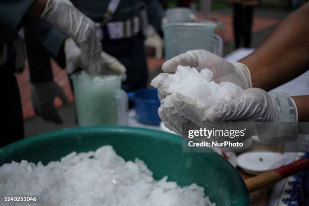 The Indonesian Navy is seen destroying evidence of methamphetamine weighing 23.98 Kilograms using a blender after being mixed with water and oil,...