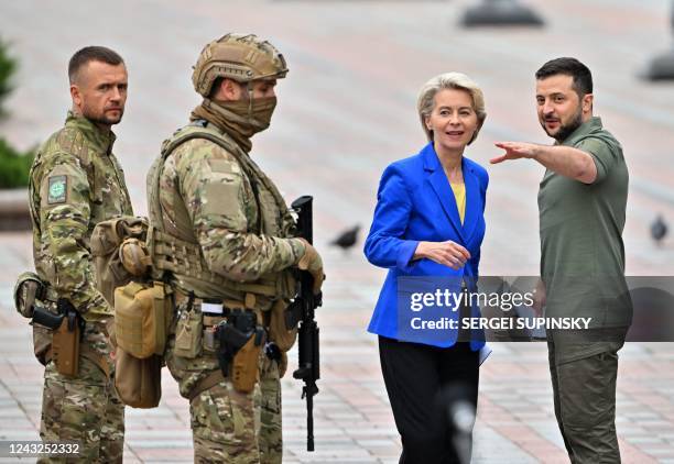 Ukrainian President Volodymyr Zelensky speaks with the President of the European Commission Ursula von der Leyen after a press conference following...