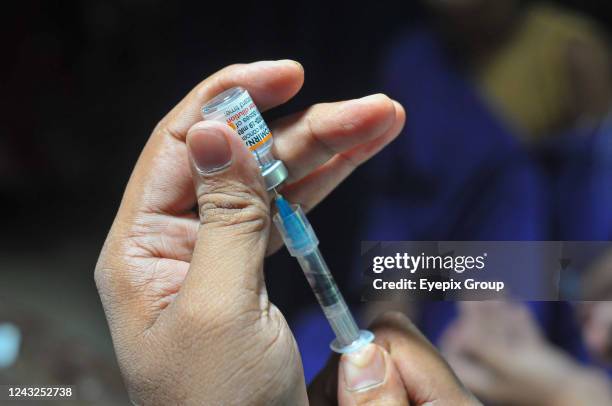 Health worker prepares a dose of Pfizer COVID-19 vaccine during the vaccination campaign for children to reduce infection rates at at Baluchor Ideal...