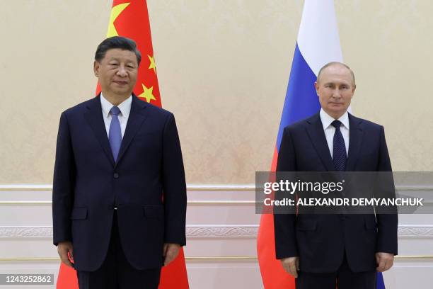 China's President Xi Jinping and Russian President Vladimir Putin pose with Mongolia's President during their trilateral meeting on the sidelines of...