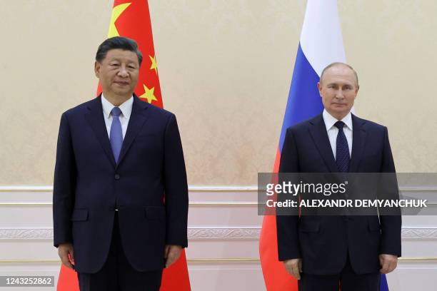 China's President Xi Jinping and Russian President Vladimir Putin pose with Mongolia's President during their trilateral meeting on the sidelines of...