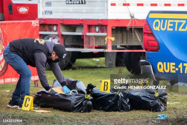 Member of the Public Ministry covers corpses after a stampede following a concert for Guatemala's independence day in Quetzaltenango, 200km west of...