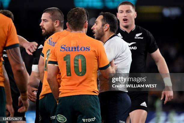 Australia's players speak with French referee Mathieu Raynal after a controversial decision during the Rugby Championship match between Australia and...