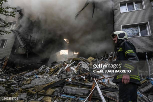 Firefighter reacts during extinguishing a fire after a flat was hit by a missile strike in Bakhmut, Donetsk region, on September 15 amid the Russian...