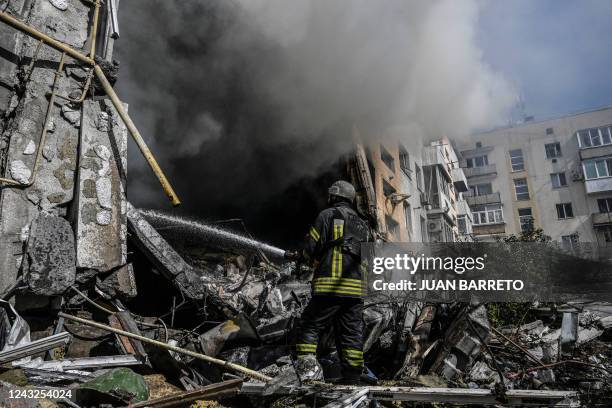 Firefighter extinguishes a fire after a flat was hit by a missile strike in Bakhmut, Donetsk region, on September 15 amid the Russian invasion of...