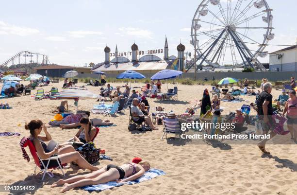 Beachgoers soak up a perfect summer day in Old Orchard Beach on Monday, July 11, 2022.