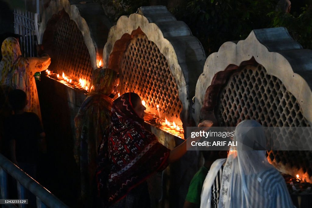 Pakistan Rufi Devotees light lamps at Data Darbar, the shrine of Sufi saint Syed ...