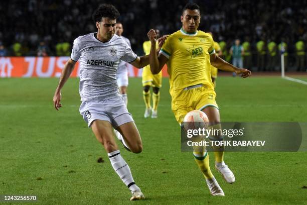 Qarabag's Azerbaijani defender Bahlul Mustafazade and Nantes' Egyptian forward Mostafa Mohamed vie for the ball during the UEFA Europa League group G...